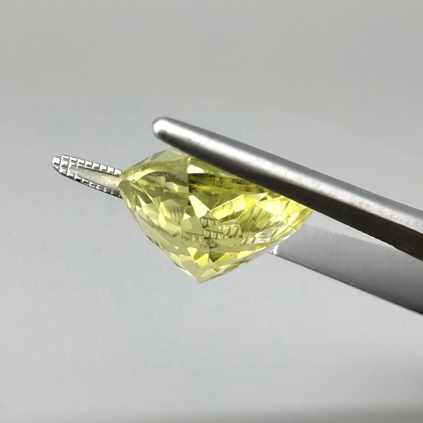 8 ct natural lemon quartz, trillion cut with bright yellow color.