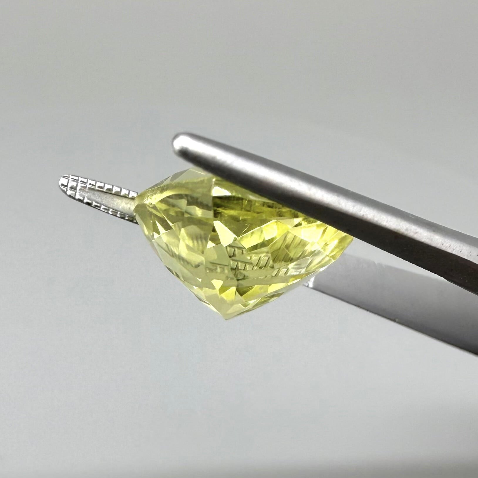 8 ct natural lemon quartz, trillion cut with bright yellow color.