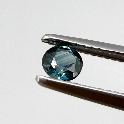 0.15 ct natural greenish-blue sapphire from Bangkaja, round cut.
