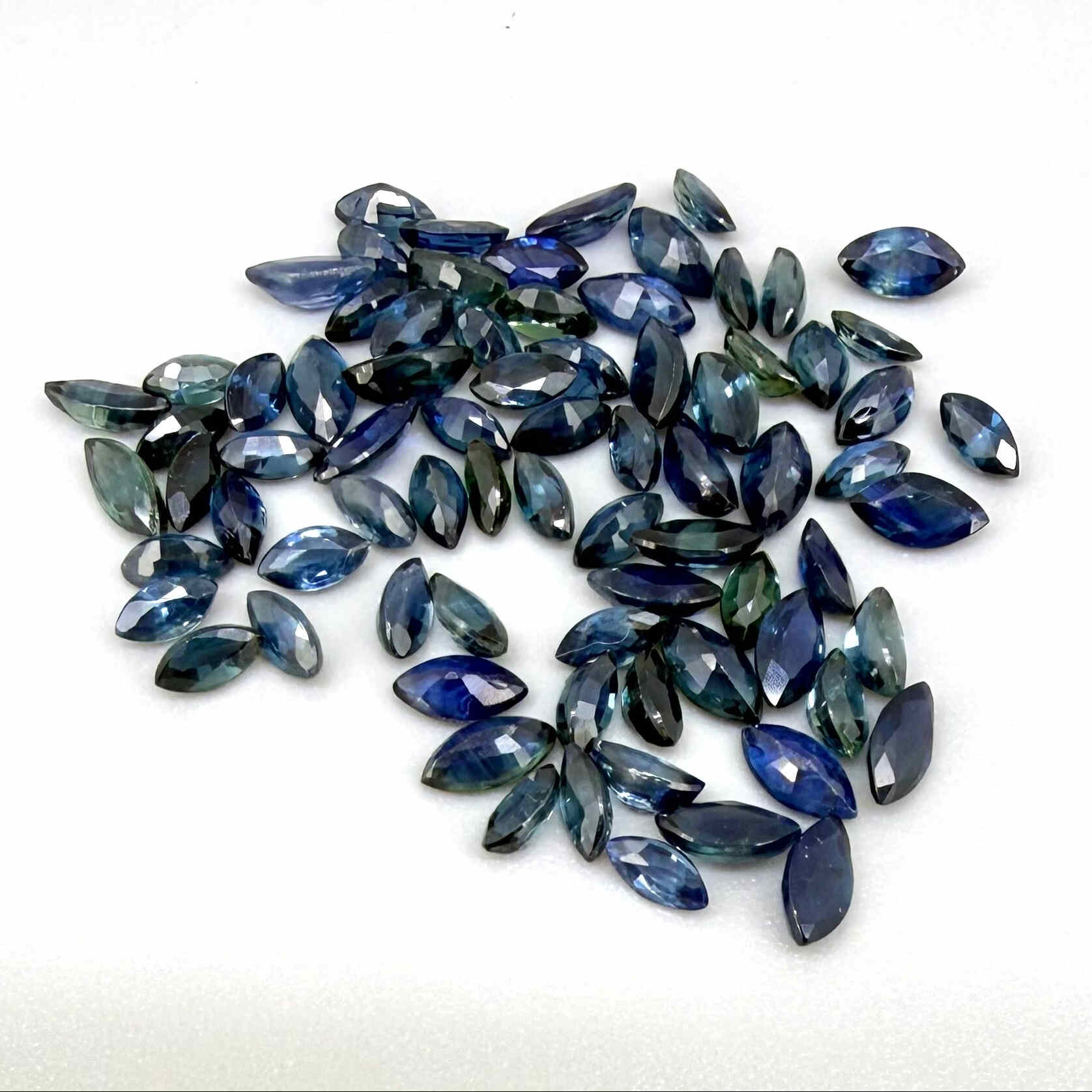 13.2 ct natural sapphire lot from Thailand, marquise cut stones in mid-to-dark vibrant blue hues.