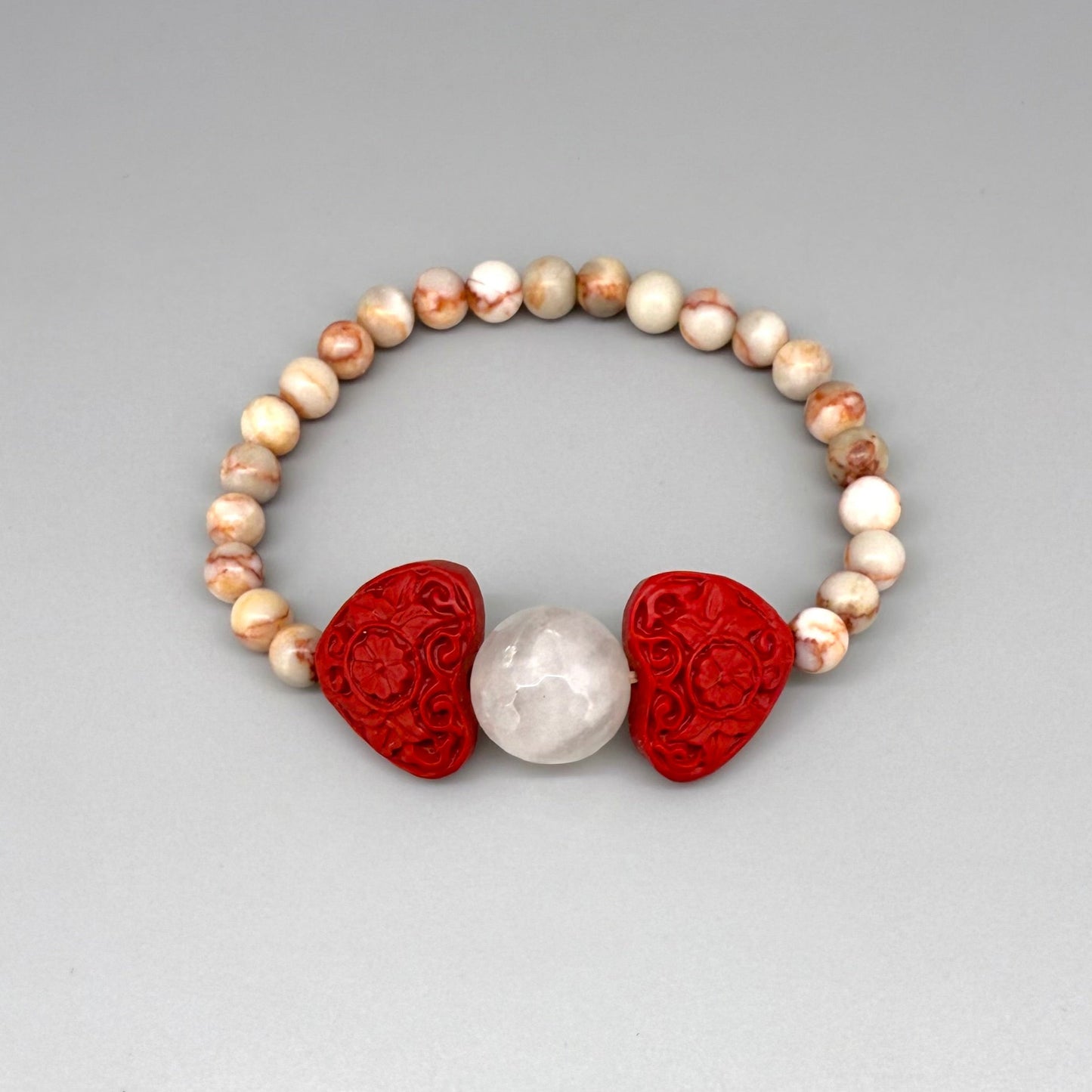 Jasper beaded bracelet, 16cm, natural earthy gemstone beads with red cinnabar-style heart and rose quartz accent on elastic stretch band.