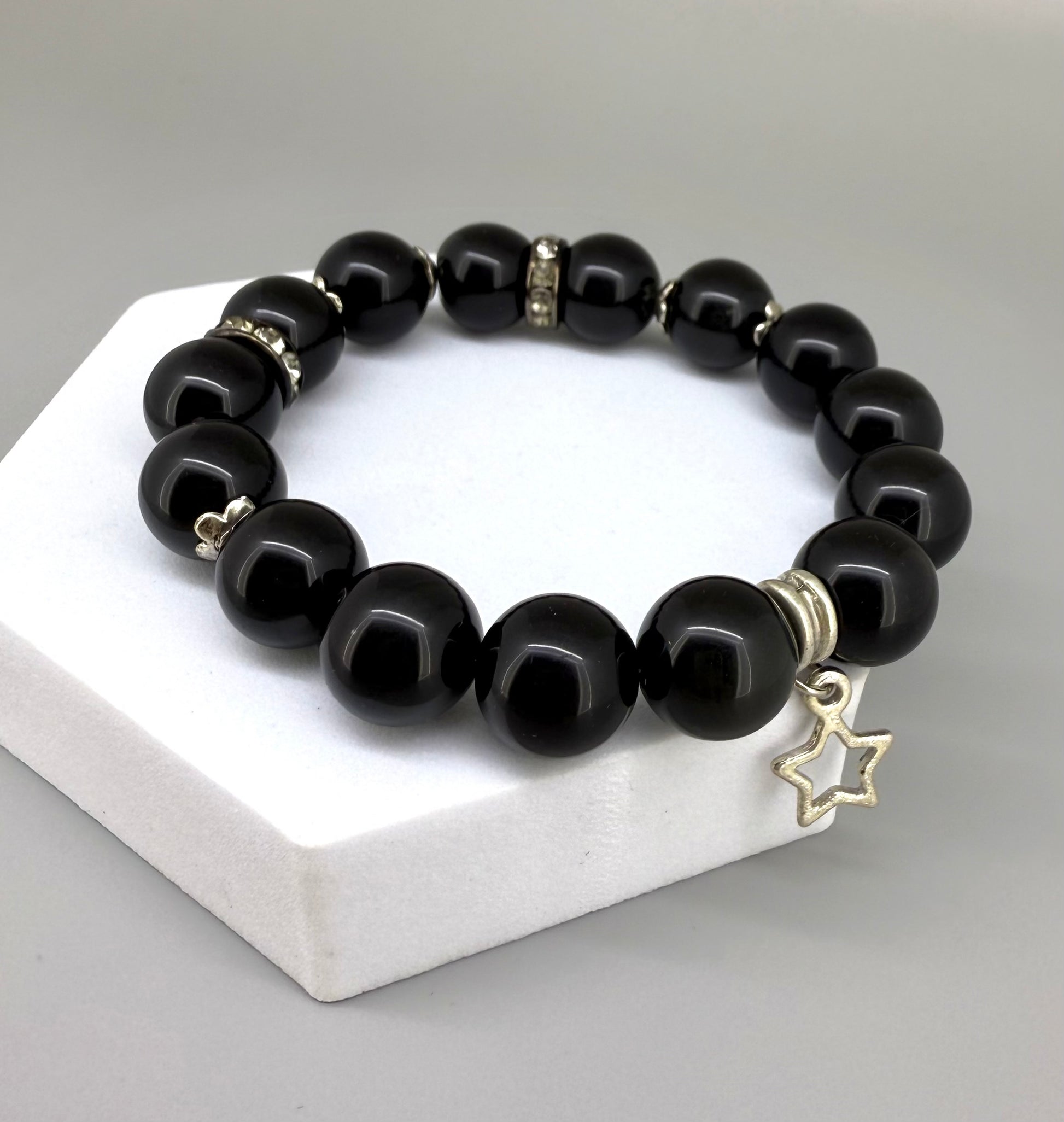 Obsidian beaded bracelet, 18cm, natural black gemstone beads with silver-toned star charm on elastic stretch band.