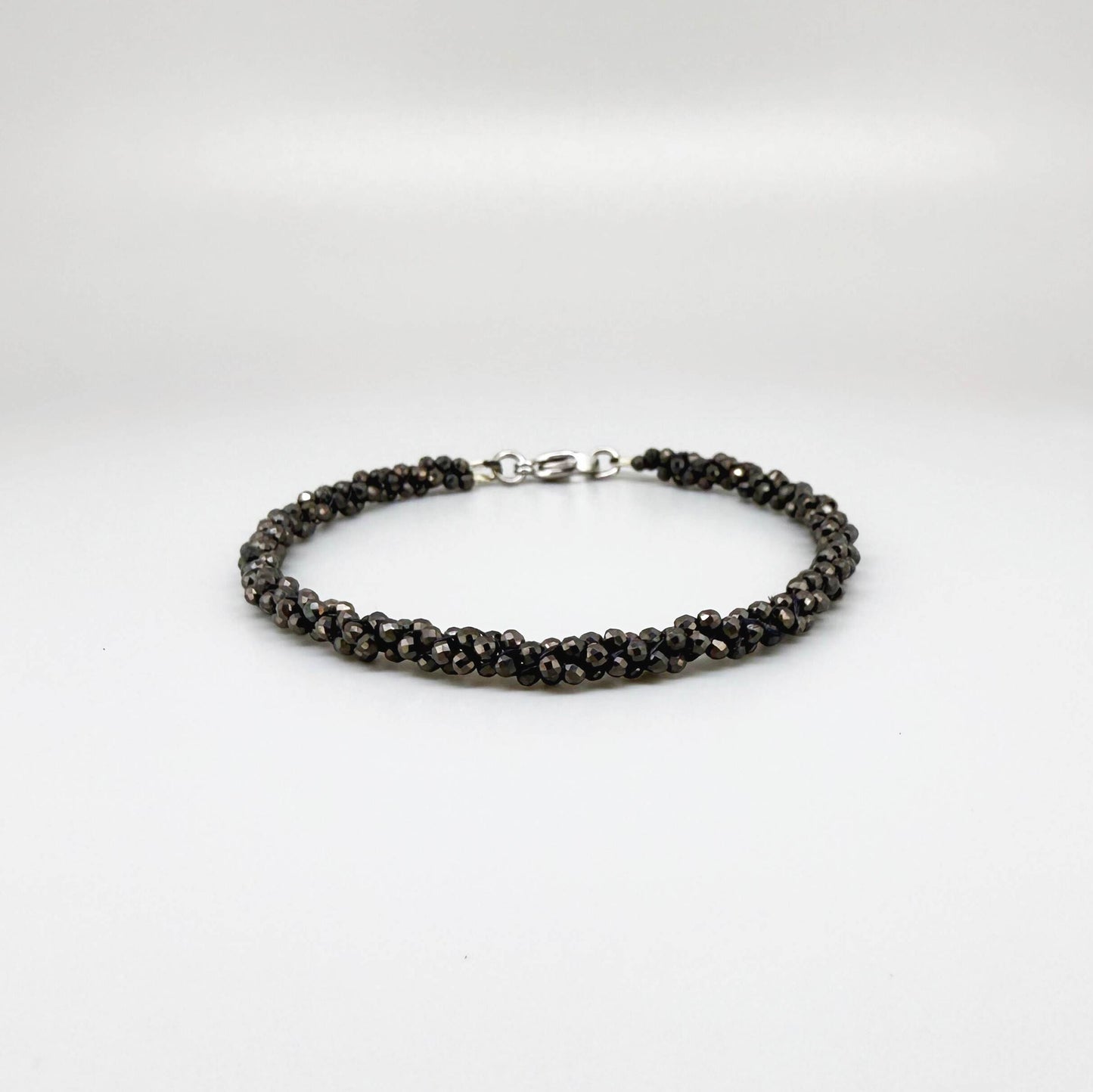 20 cm beaded bracelet made of faceted near-black hematite with a lobster clasp, displayed on a light background.