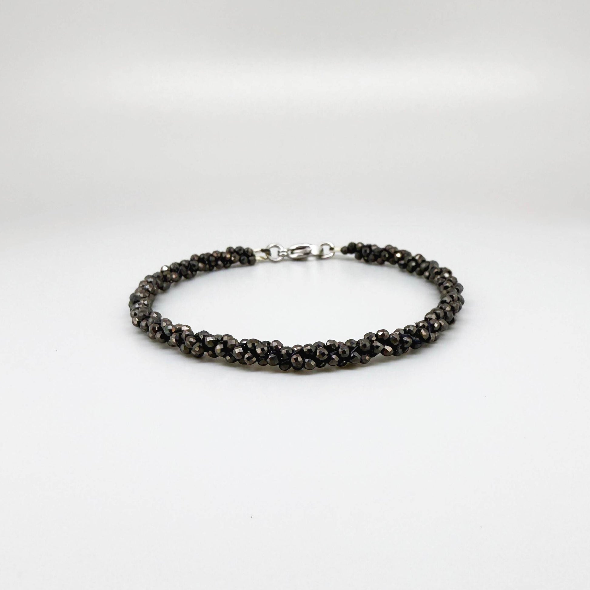 20 cm beaded bracelet made of faceted near-black hematite with a lobster clasp, displayed on a light background.