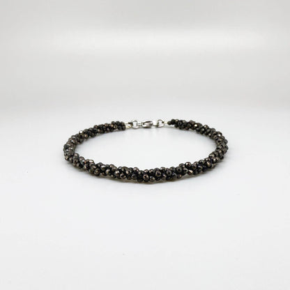 20 cm beaded bracelet made of faceted near-black hematite with a lobster clasp, displayed on a light background.