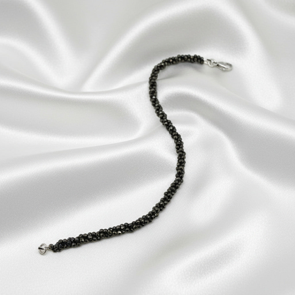 20 cm beaded bracelet made of faceted near-black hematite with a lobster clasp, displayed on a light background.