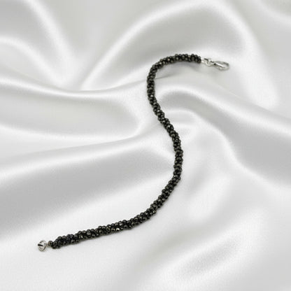 20 cm beaded bracelet made of faceted near-black hematite with a lobster clasp, displayed on a light background.