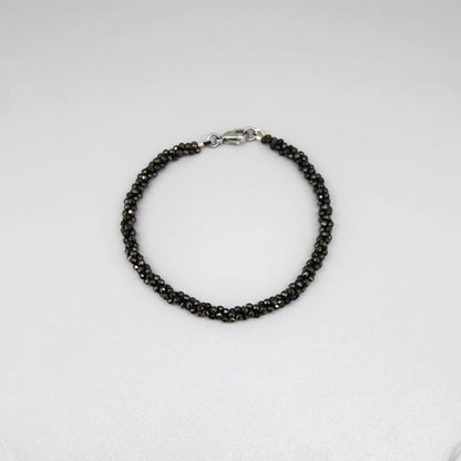 20 cm beaded bracelet made of faceted near-black hematite with a lobster clasp, displayed on a light background.