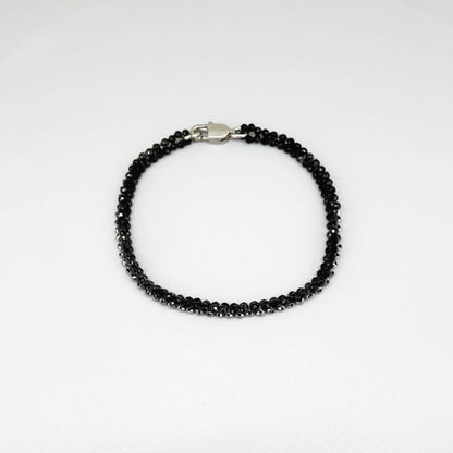 18 cm bracelet made from faceted black spinel and silver hematite beads with a lobster clasp.