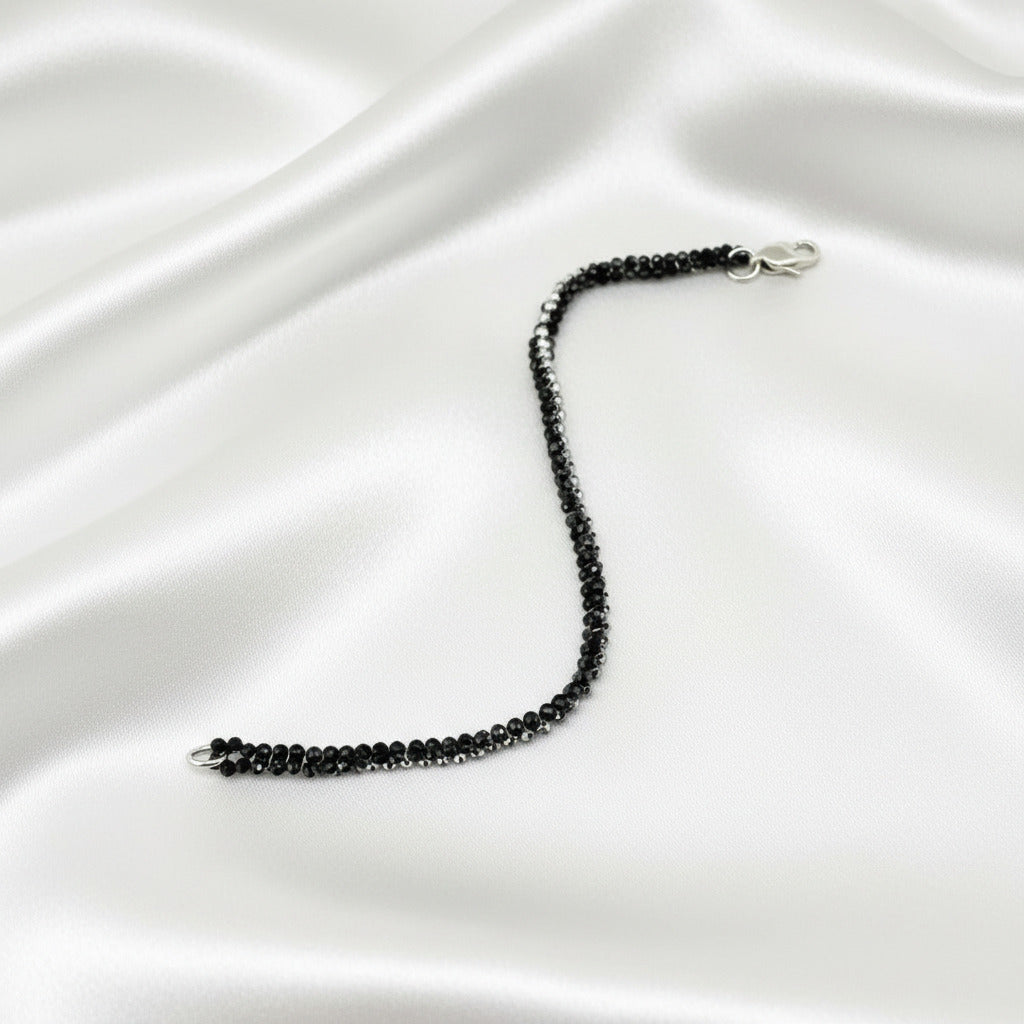 18 cm bracelet made from faceted black spinel and silver hematite beads with a lobster clasp.