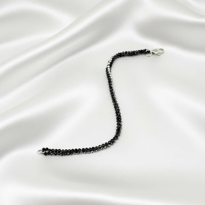 18 cm bracelet made from faceted black spinel and silver hematite beads with a lobster clasp.