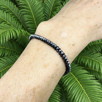 18 cm bracelet made from faceted black spinel and silver hematite beads with a lobster clasp.