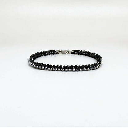 18 cm bracelet made from faceted black spinel and silver hematite beads with a lobster clasp.