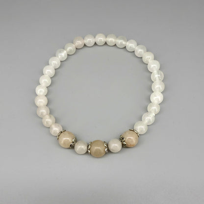 Jade beaded bracelet, 19cm, natural green gemstone beads with three slightly larger darker accent stones on elastic stretch band.