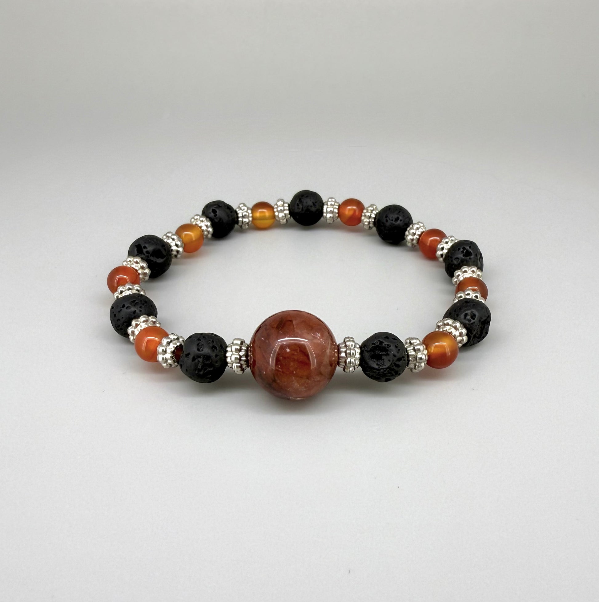 Alt-Text

Carnelian, lava, and cherry quartz beaded bracelet, 18cm, natural orange-red, matte black, and pink beads on elastic stretch band.