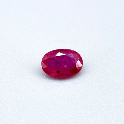 0.6 ct natural Songea ruby, oval cut in a pink-red tone.
