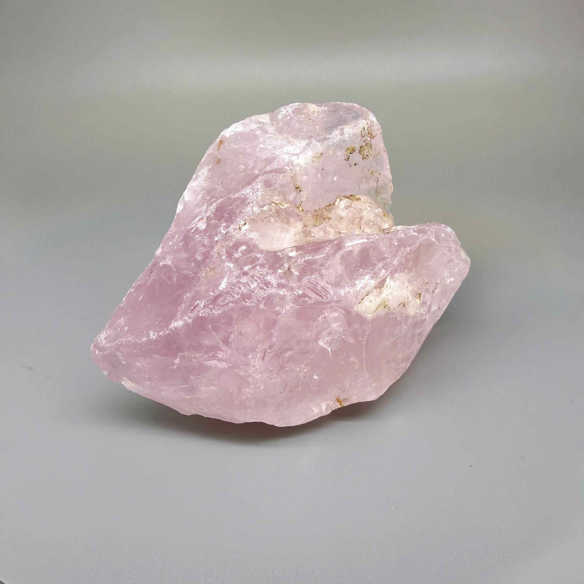 Natural rose quartz rough stone, translucent untreated pink quartz in raw form photographed in natural light
