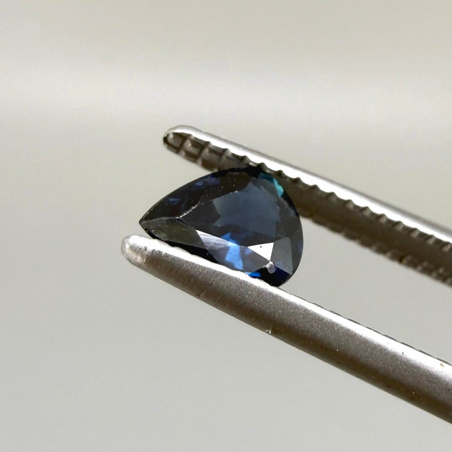 0.35 ct natural dark-blue sapphire from Bangkaja, pear cut.