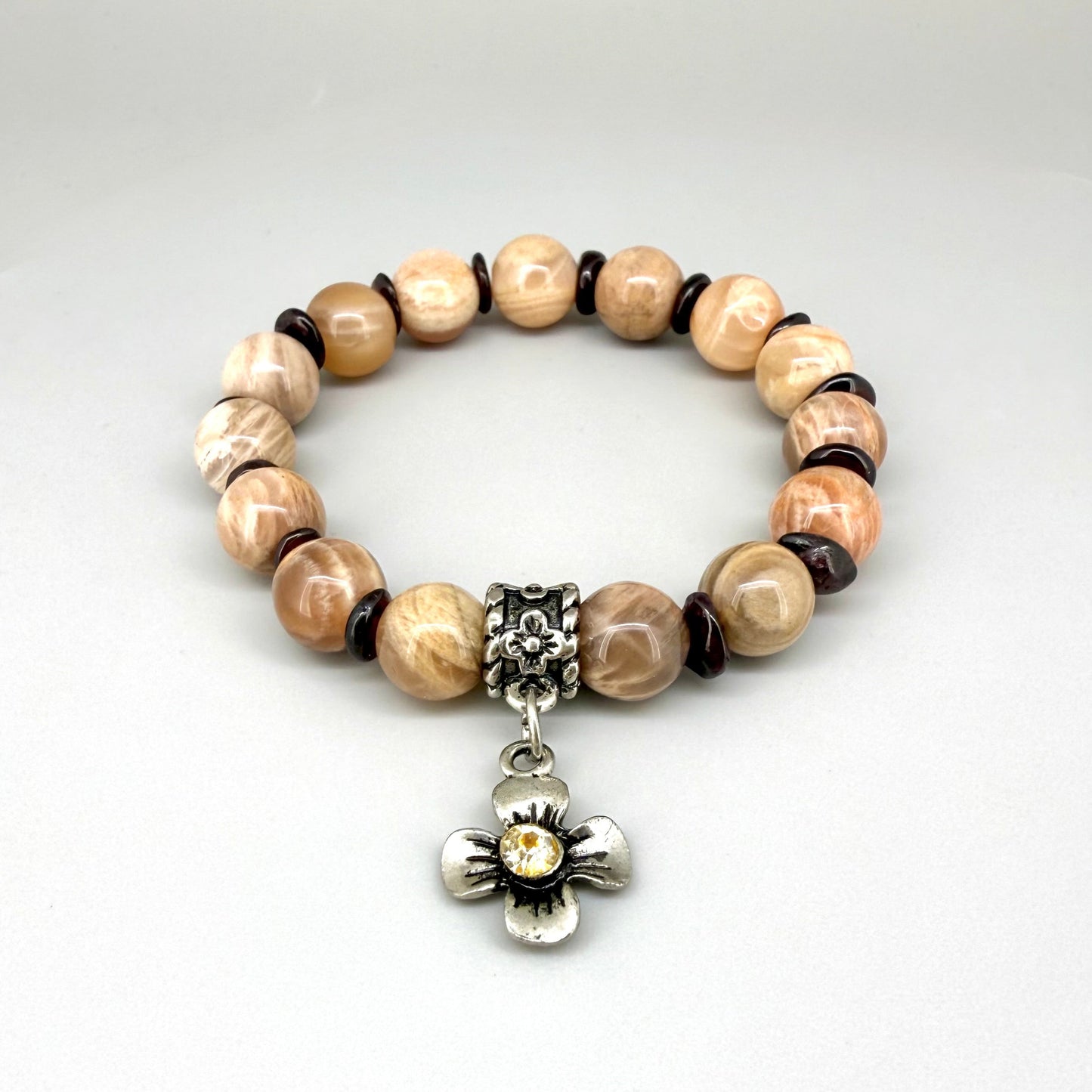 Sunstone and garnet chip beaded bracelet, 18cm, beige and brown gemstone beads with red garnet chips and flower charm on elastic stretch band.