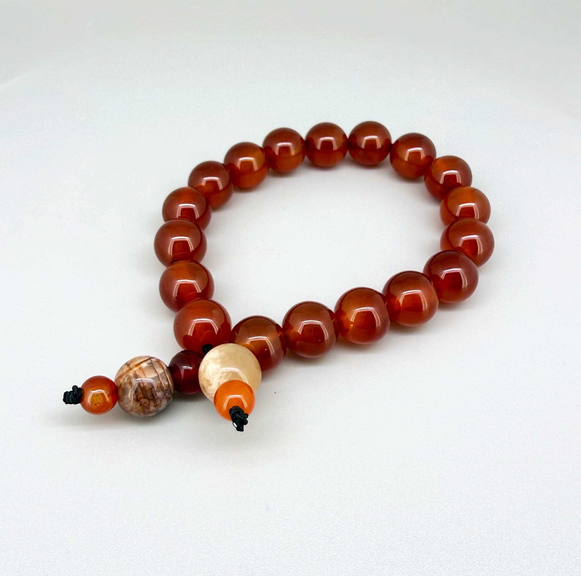 Carnelian mala bracelet made from natural warm orange-red carnelian beads, designed for grounding, vitality, and everyday wear.