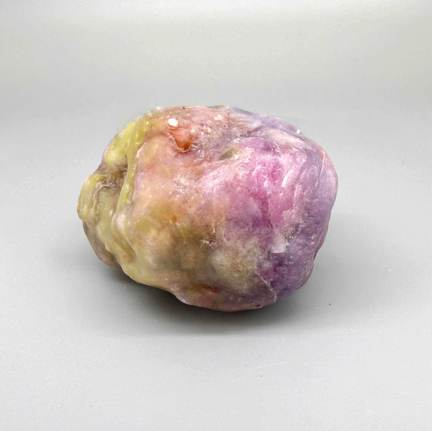 Natural ruby rough stone in lilac to purplish-pink tones, uncut corundum specimen.