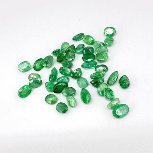 8.9 ct natural untreated Zambian emerald lot, faceted oval stones with vivid bluish-green color.