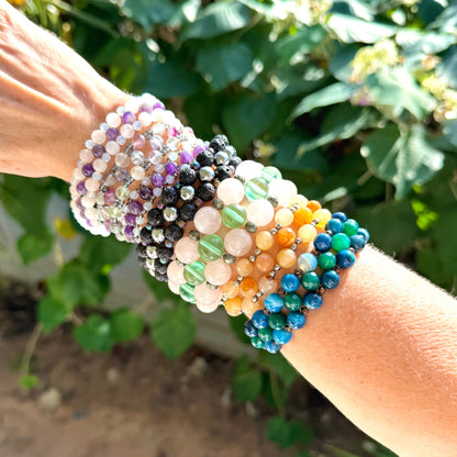 Multicolored beaded bracelets on a wrist with a natural background