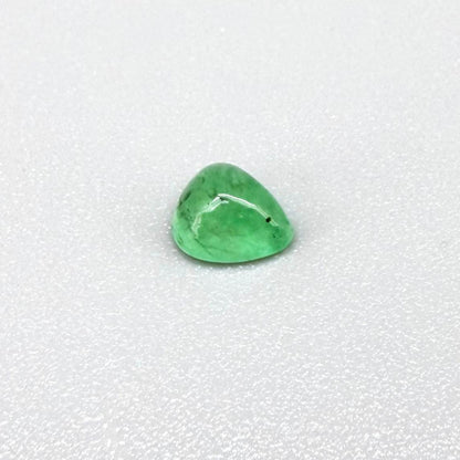 0.51 ct natural untreated emerald from Zambia, one side polished and the other cabochon-shaped.