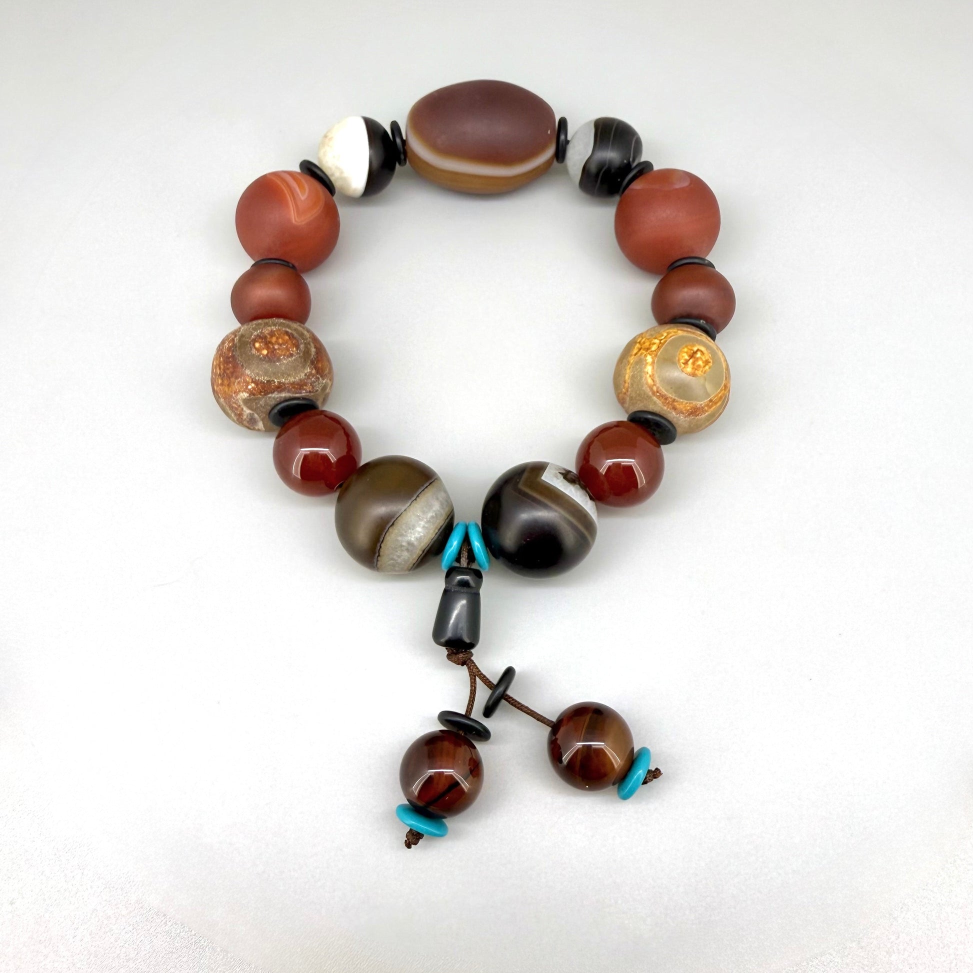 Agate and carnelian beaded bracelet, 20cm, with fiery red, brown, and colorful accent beads on elastic stretch band.