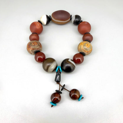 Agate and carnelian beaded bracelet, 20cm, with fiery red, brown, and colorful accent beads on elastic stretch band.