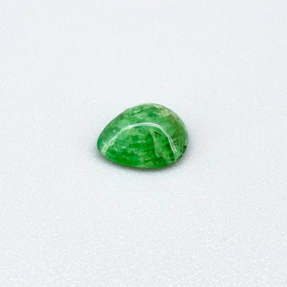 0.75 ct natural untreated emerald from Zambia, one side polished and the other cabochon-shaped.