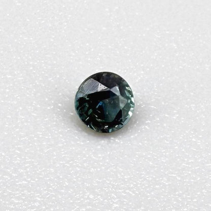 0.15 ct natural greenish-blue sapphire from Bangkaja, round cut.