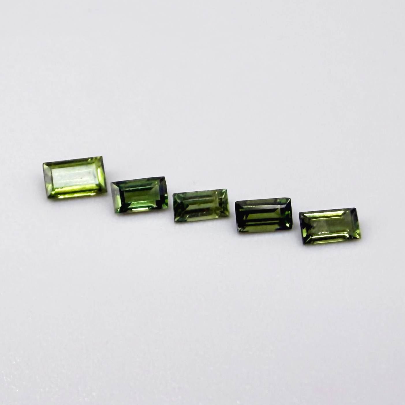 1.06 ct natural green sapphire lot from Thailand, baguette cut stones.