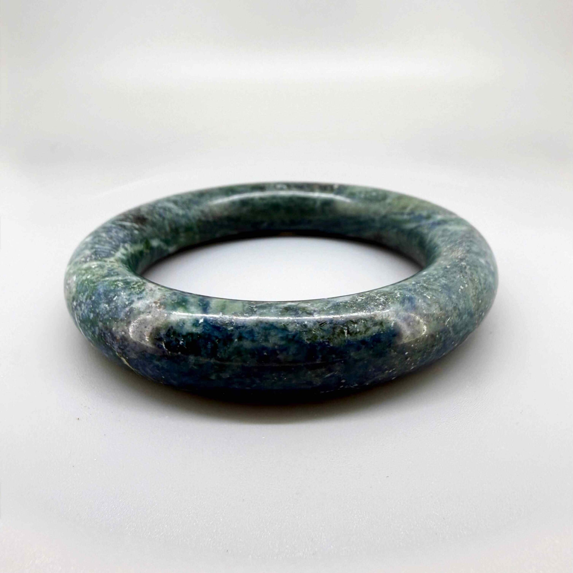 Polished green-blue jade bangle with smooth surface and natural color variations, 20 cm inner circumference