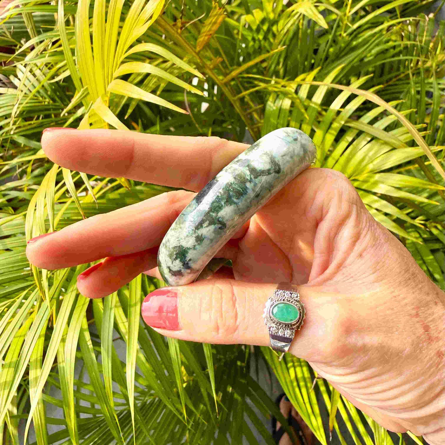 Polished jade bangle in soft green hues with smooth surface and natural variations, 20 cm inner circumference