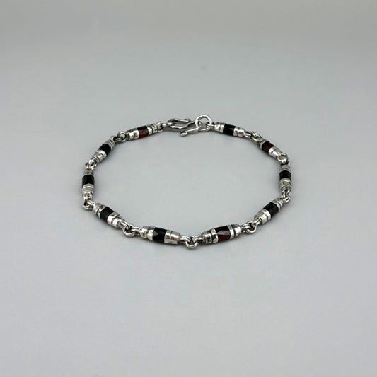 Garnet Pyrope bracelet in sterling silver with white gold plating, elegant design on neutral background