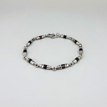 Garnet Pyrope bracelet in sterling silver with white gold plating, elegant design on neutral background