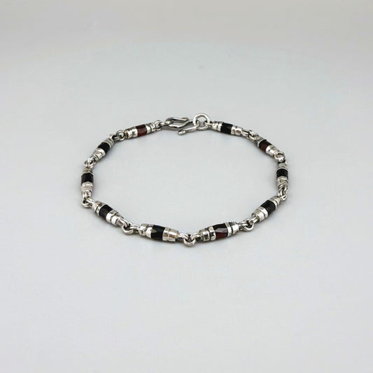 Garnet Pyrope bracelet in sterling silver with white gold plating, elegant design on neutral background