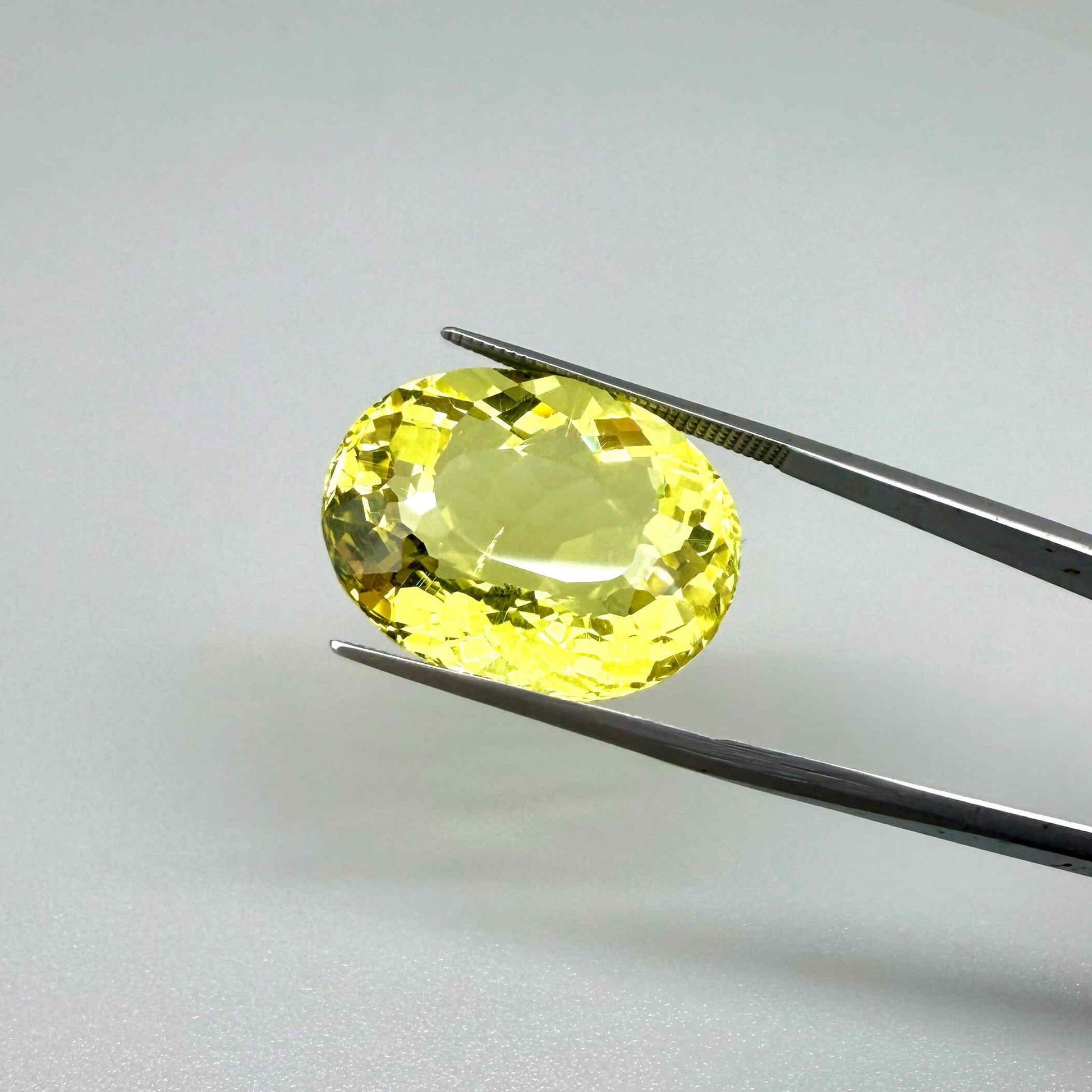 28.09 ct natural lemon quartz from Africa, oval cut with bright yellow color.