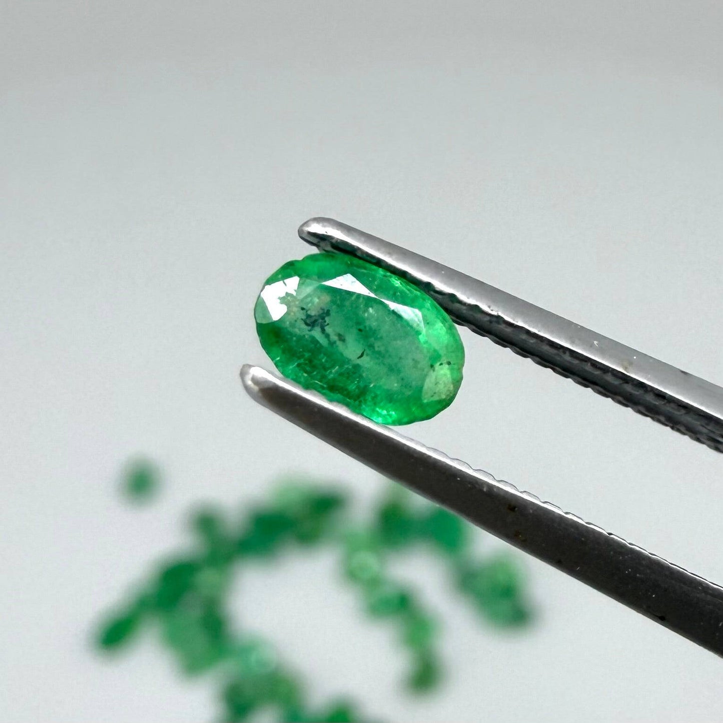 8.9 ct natural untreated Zambian emerald lot, faceted oval stones with vivid bluish-green color.