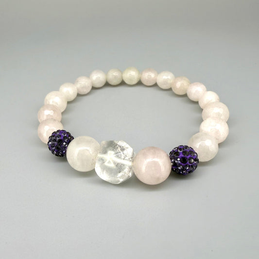Rose quartz beaded bracelet, 19cm, light pink gemstone beads with larger central rose quartz bead and black sparkling accent beads on elastic stretch band.