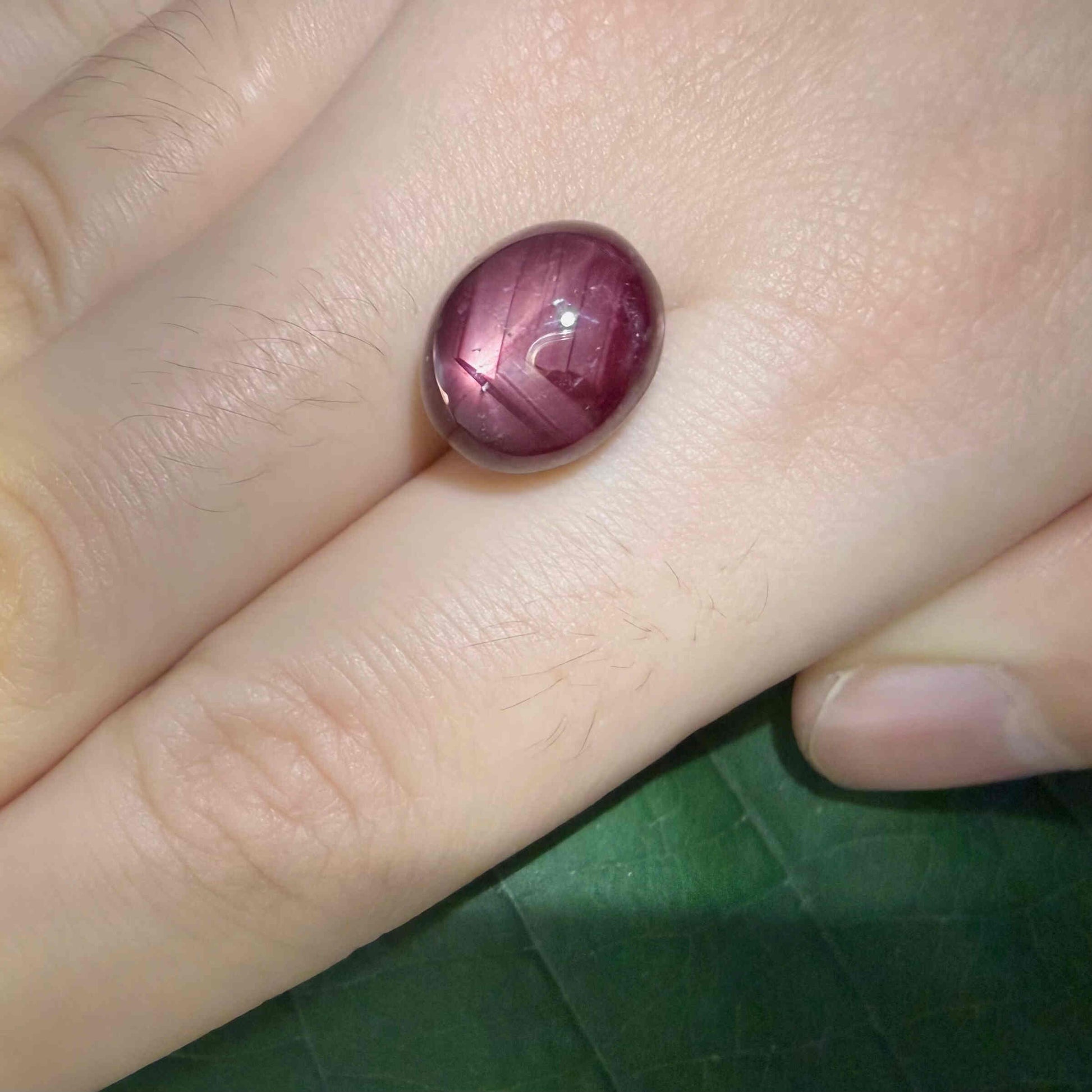 14.4 ct natural Pink-Red Star Ruby cabochon from Mozambique with soft star effect and polished dome.