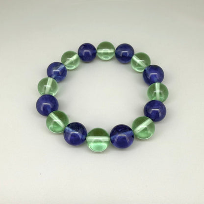 Quartz beaded bracelet, 18cm, alternating dark blue and light green dyed gemstone beads on elastic stretch band.