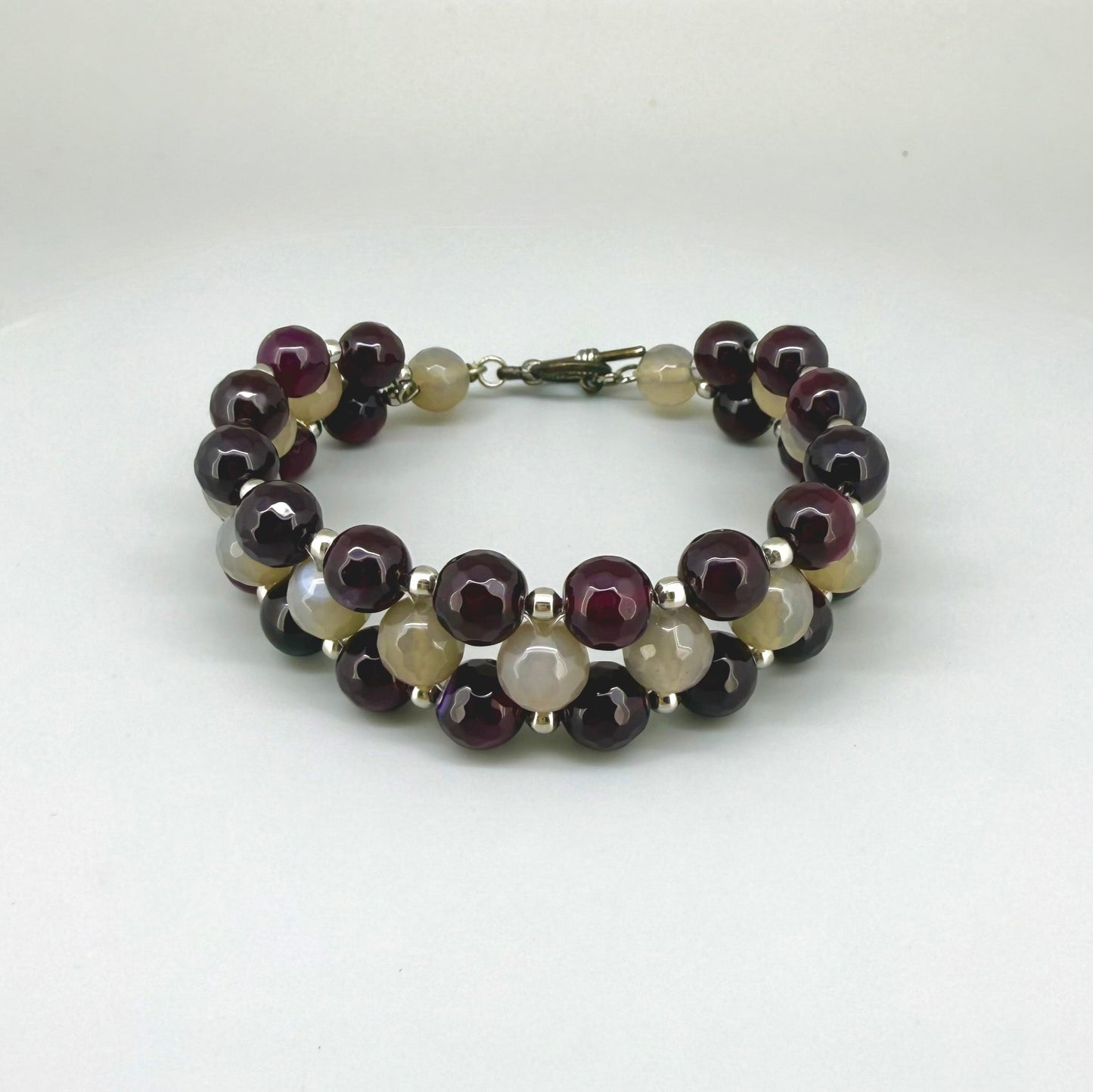 Three-row agate beaded bracelet, 20cm, with deep violet-red outer rows and lighter agate center beads on elastic stretch band.