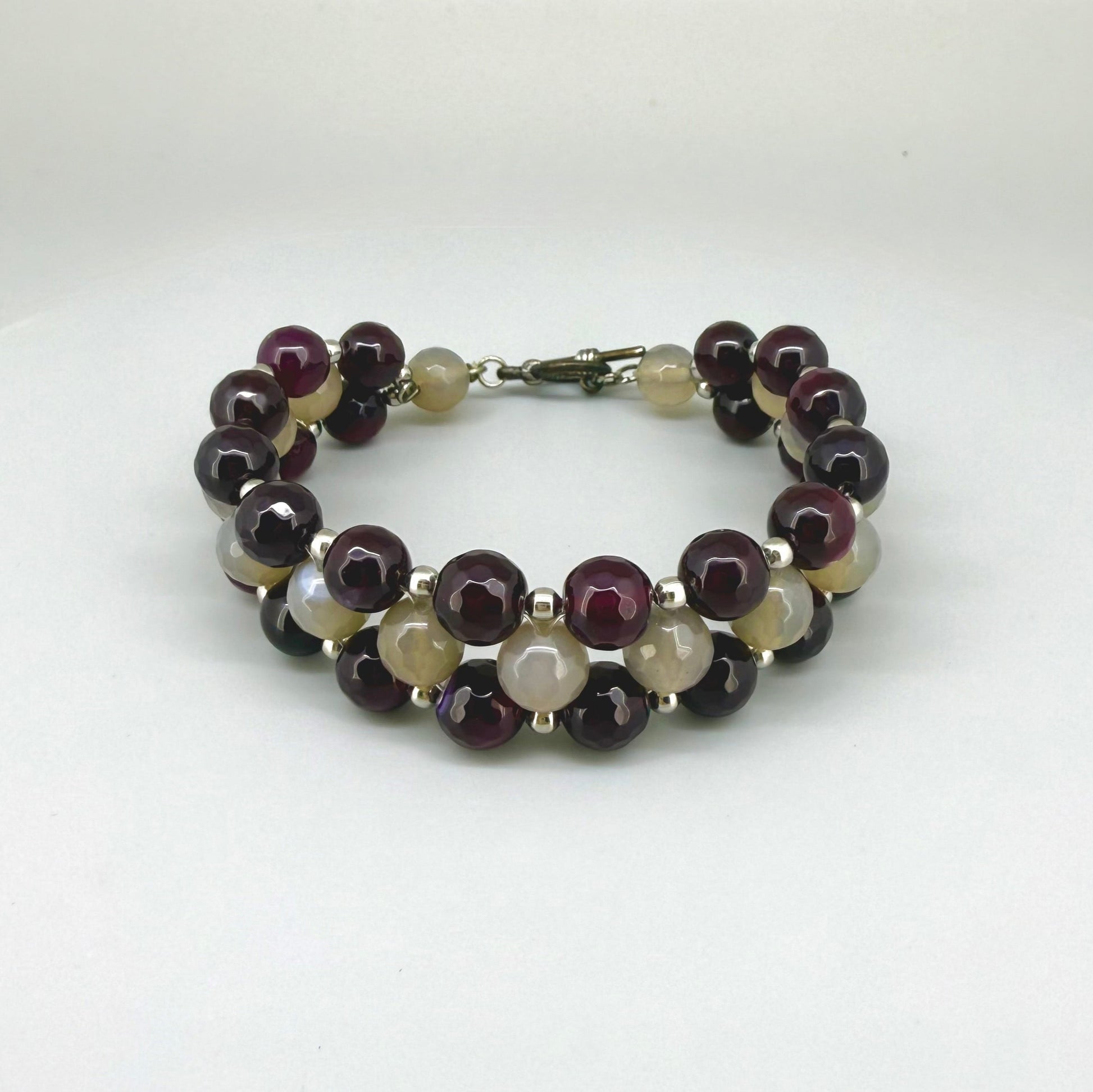 Three-row agate beaded bracelet, 20cm, with deep violet-red outer rows and lighter agate center beads on elastic stretch band.
