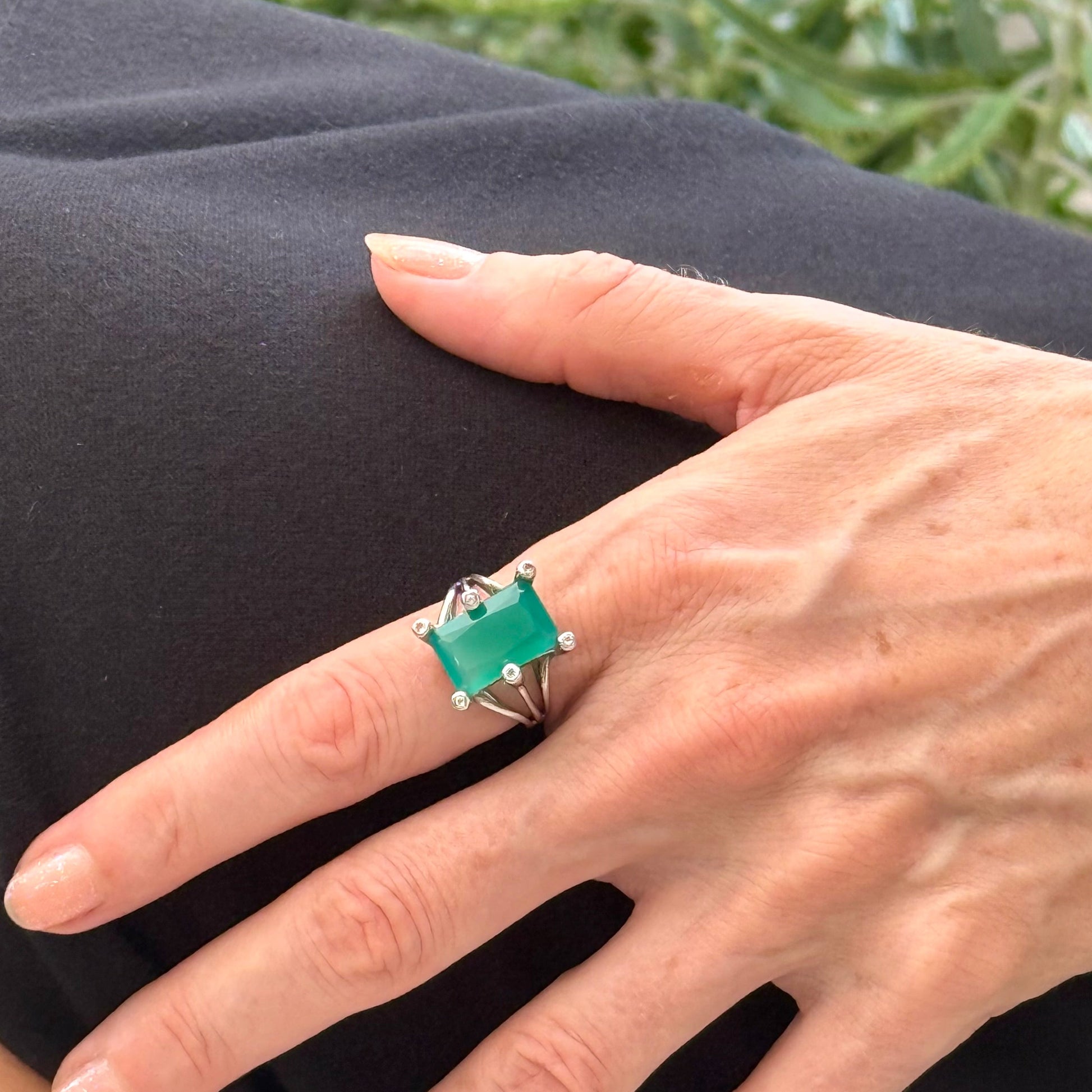 White gold plated sterling silver ring with emerald-cut green chalcedony, elegant solitaire design with soft natural glow.