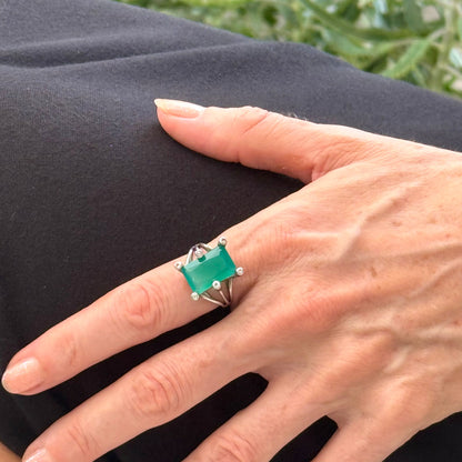 White gold plated sterling silver ring with emerald-cut green chalcedony, elegant solitaire design with soft natural glow.