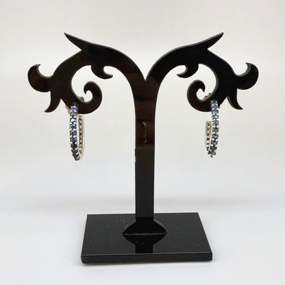 Elegant hoop earrings in white gold plated sterling silver set with natural blue sapphires.