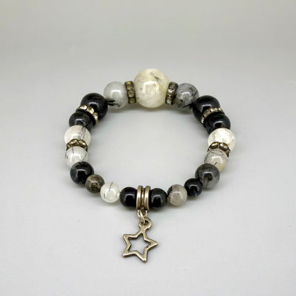 Rutilated quartz beaded bracelet, 18cm, black rutile inclusions with larger light bead and star charm on elastic stretch band.