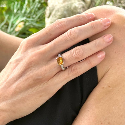 Citrine and CZ ring in white gold plated sterling silver, featuring a faceted golden gemstone framed by clear cubic zirconia, elegant and radiant design.